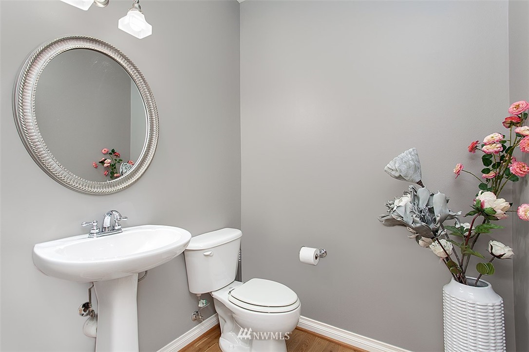 258 Lyons Place Northeast Renton, WA 98059 - Photo 14 of 25 a bathroom with a toilet sink and mirror