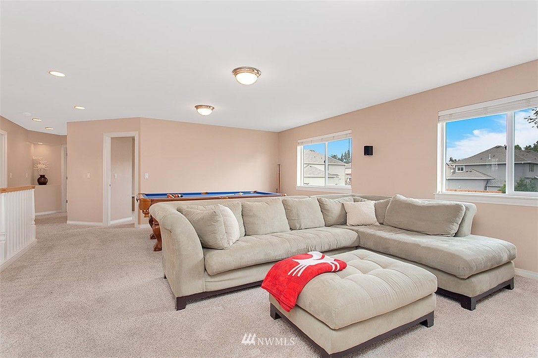 258 Lyons Place Northeast Renton, WA 98059 - Photo 17 of 25 a living room with furniture and a large window