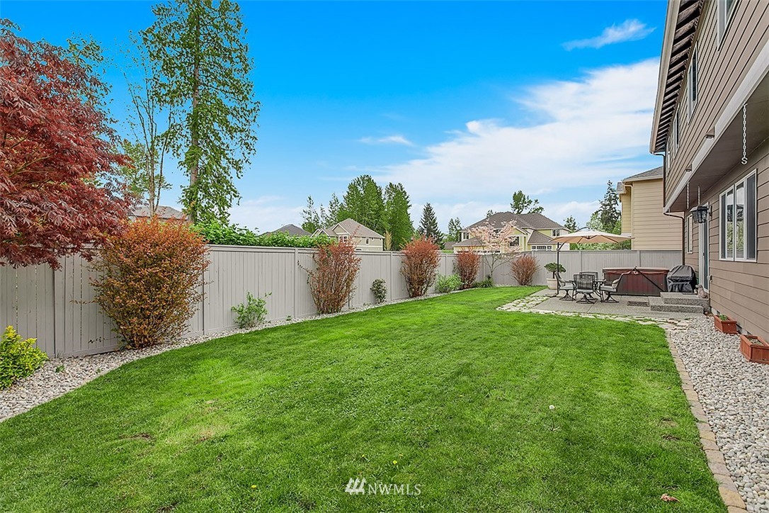 258 Lyons Place Northeast Renton, WA 98059 - Photo 25 of 25 a view of a garden with a building in the background