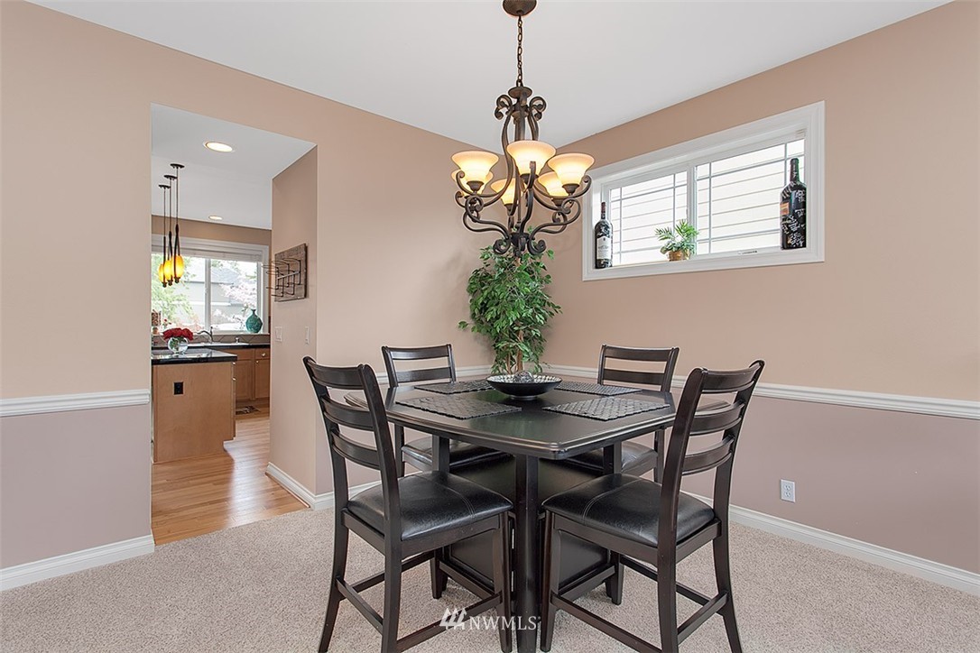258 Lyons Place Northeast Renton, WA 98059 - Photo 5 of 25 a view of a dining room with furniture and chandelier