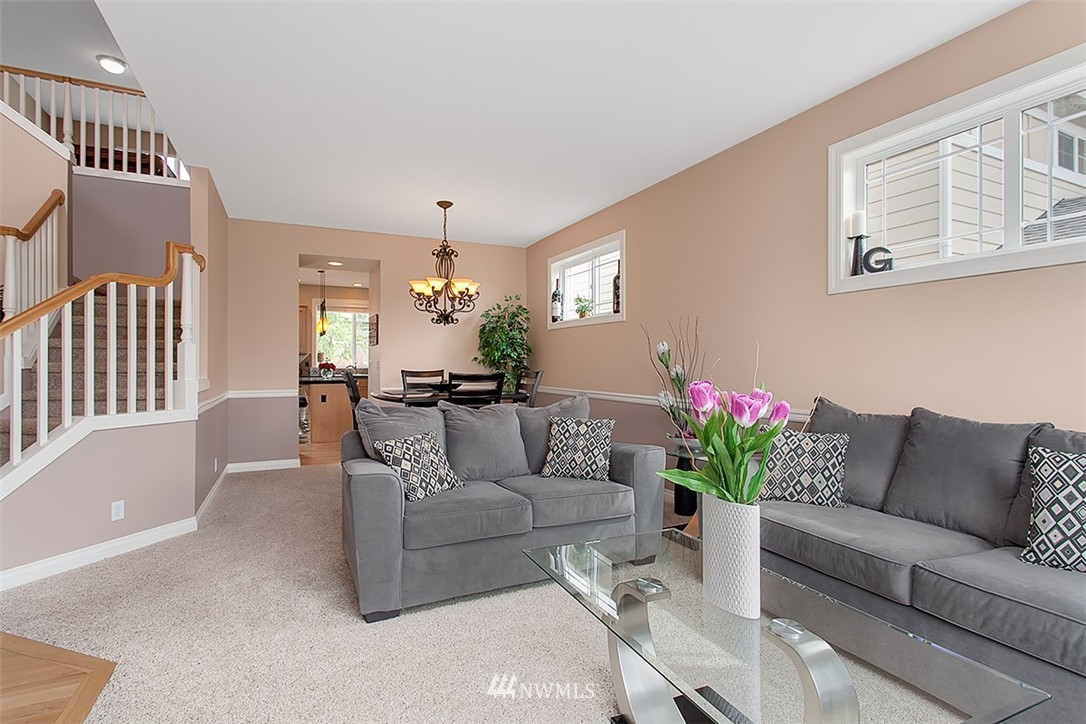 258 Lyons Place Northeast Renton, WA 98059 - Photo 6 of 25 a living room with furniture and a chandelier