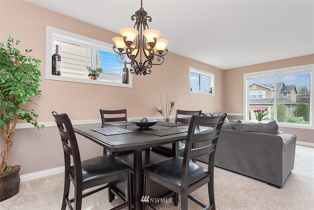 258 Lyons Place Northeast Renton, WA 98059 - Photo 7 of 25 a view of a dining room with furniture wooden floor and chandelier