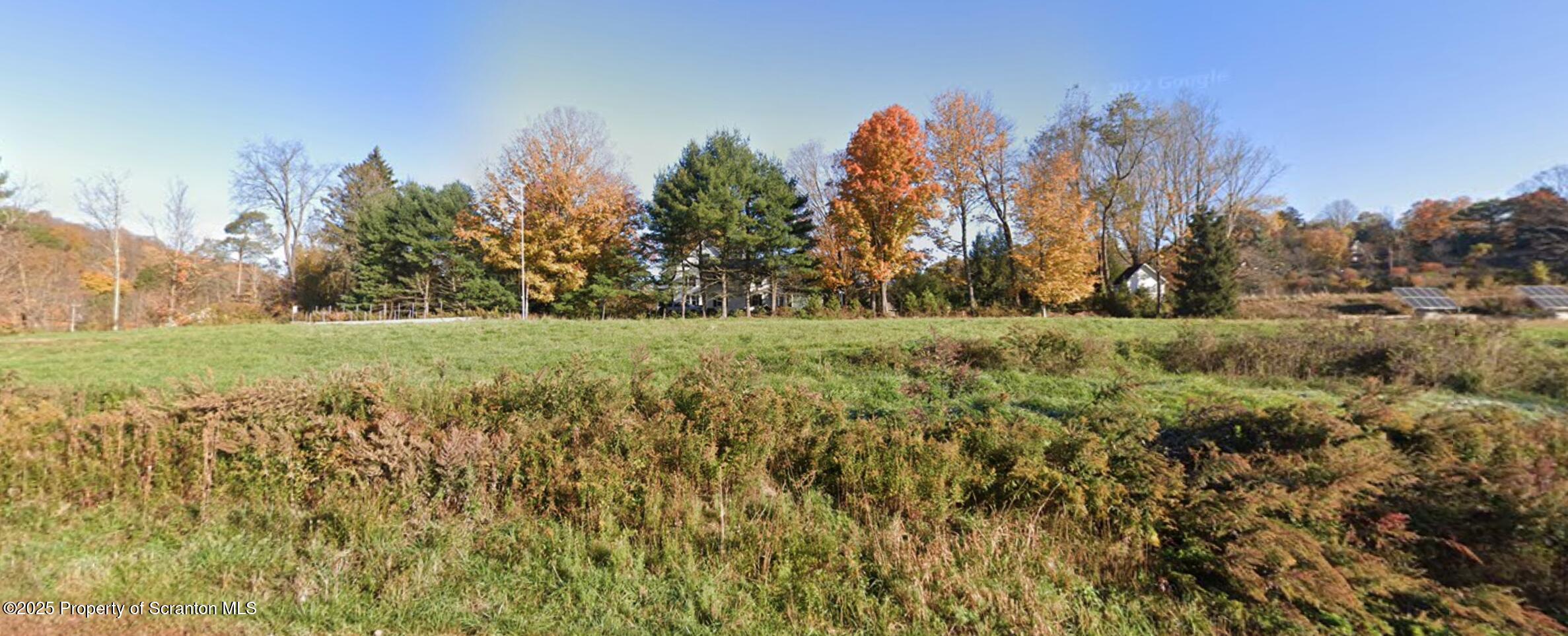 Ackerly Road Dalton, PA 18414 - Photo 3 of 3 a view of a field with trees in the background