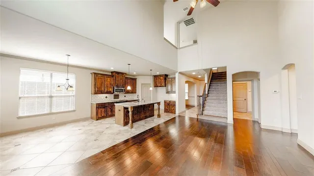 a bathroom with a tub sink vanity and mirror