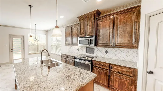 a large kitchen with cabinets and stainless steel appliances