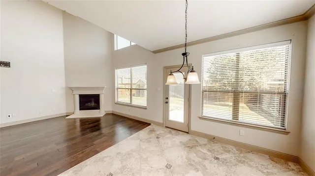 a kitchen with a table chairs and refrigerator