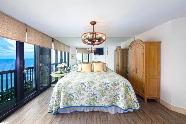 a bedroom with a bed mirror and window