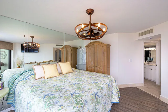 a bedroom with a bed and a chandelier