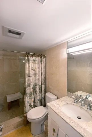 a bathroom with a sink toilet and shower