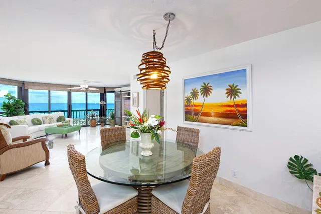 a dining room with furniture a rug and a chandelier
