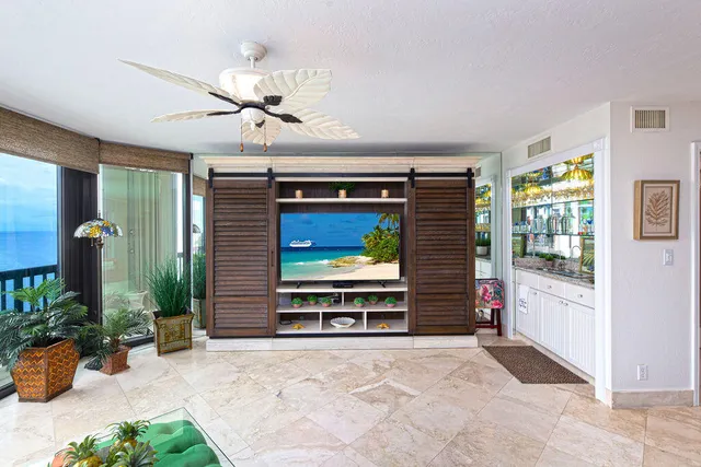 a view of a livingroom with furniture and a ceiling fan