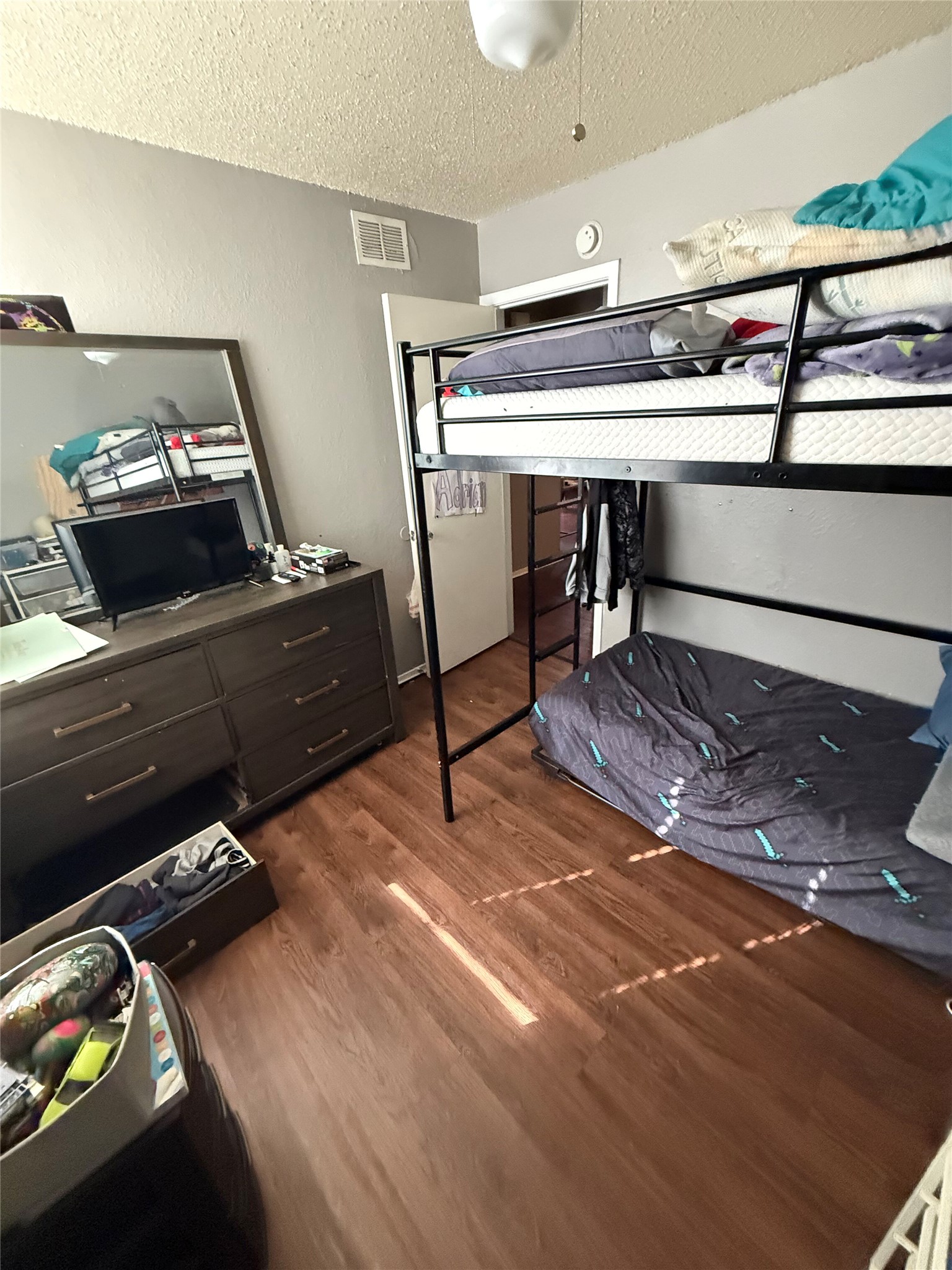 11905 Alpheus Avenue Austin, TX 78759 - Photo 11 of 23 a bedroom with a bed and a dresser