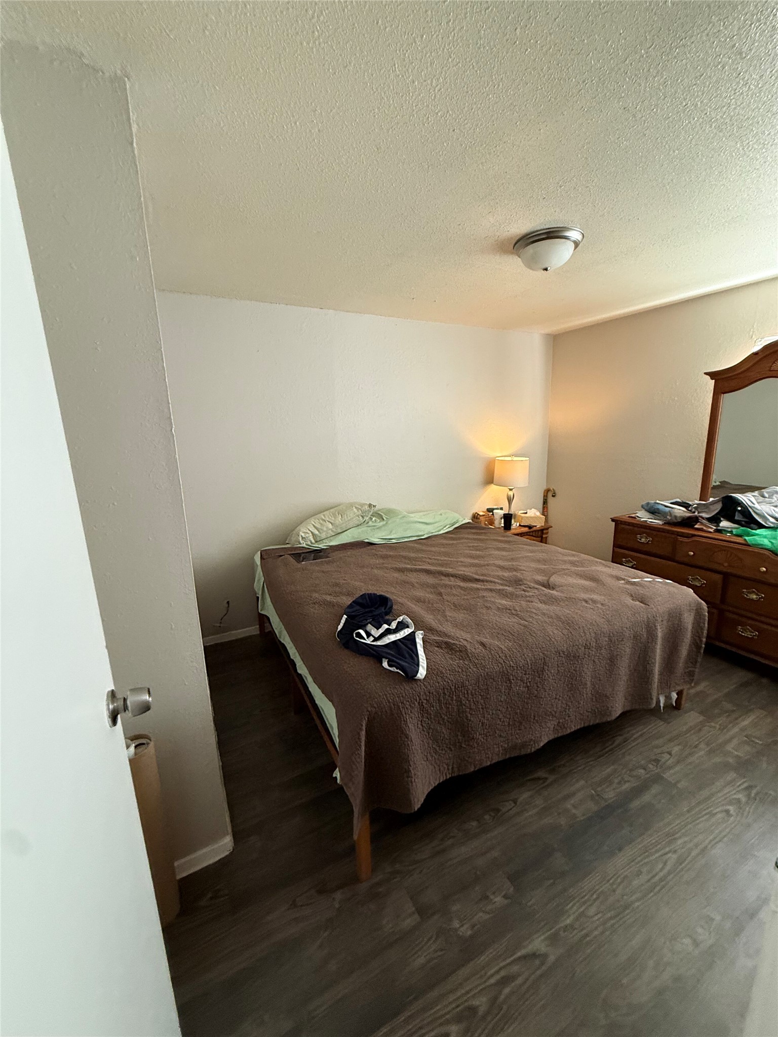 11905 Alpheus Avenue Austin, TX 78759 - Photo 5 of 23 a bedroom with a bed and wooden floor