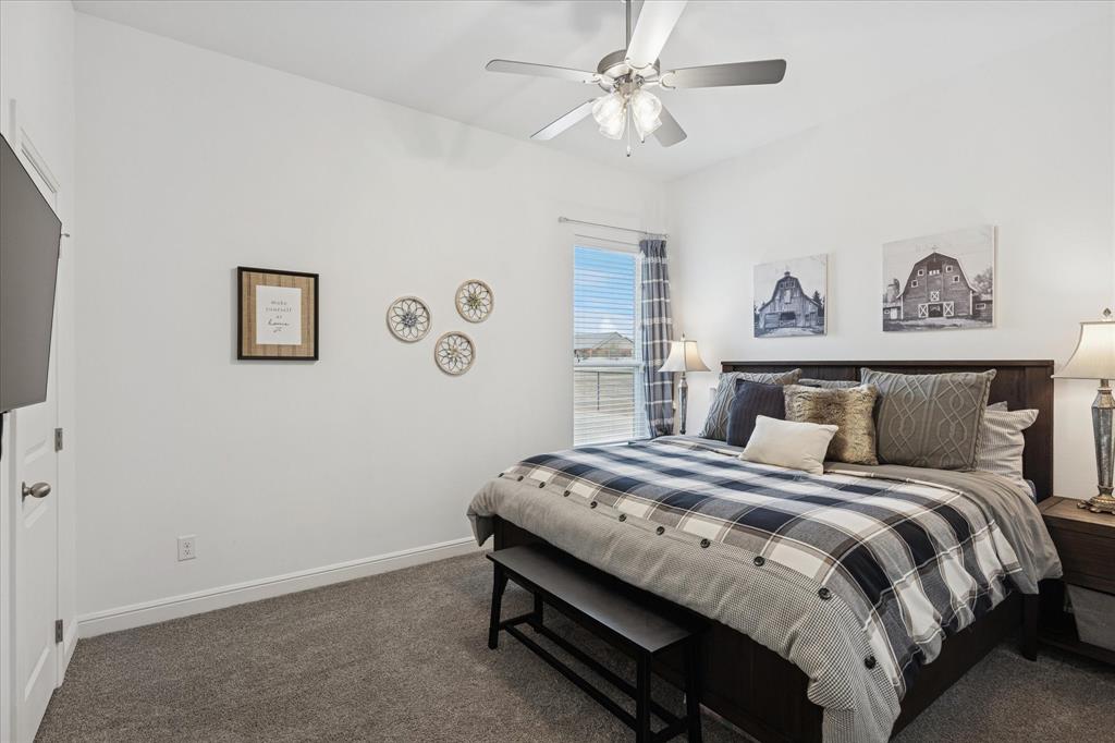112 Friendship Way Boyd, TX 76023 - Photo 19 of 29 Carpeted bedroom featuring a ceiling fan with integrated lighting, a window with horizontal blinds, and white baseboards