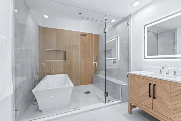 a bathroom with a tub a sink and a shower