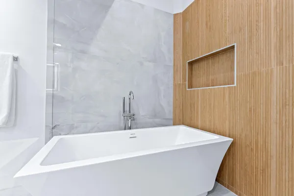 a bath tub sitting next to a white sink