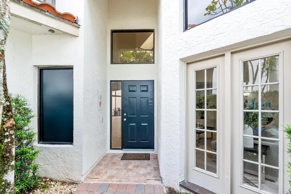a view of a patio with table and chairs and potted plants
