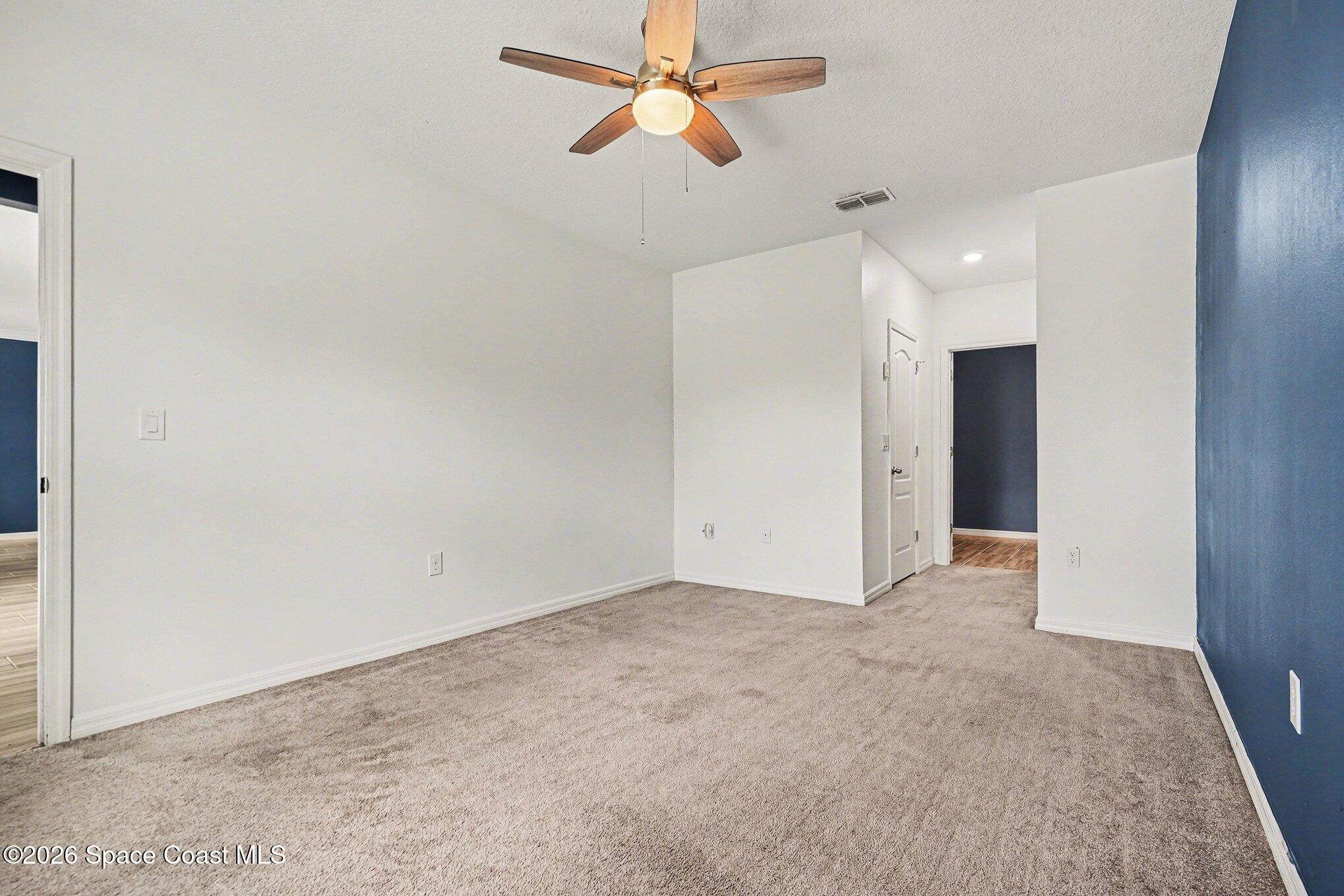 414 Hancock Street Palm Bay, FL 32908 - Photo 11 of 31 an empty room with closet and a chandelier fan