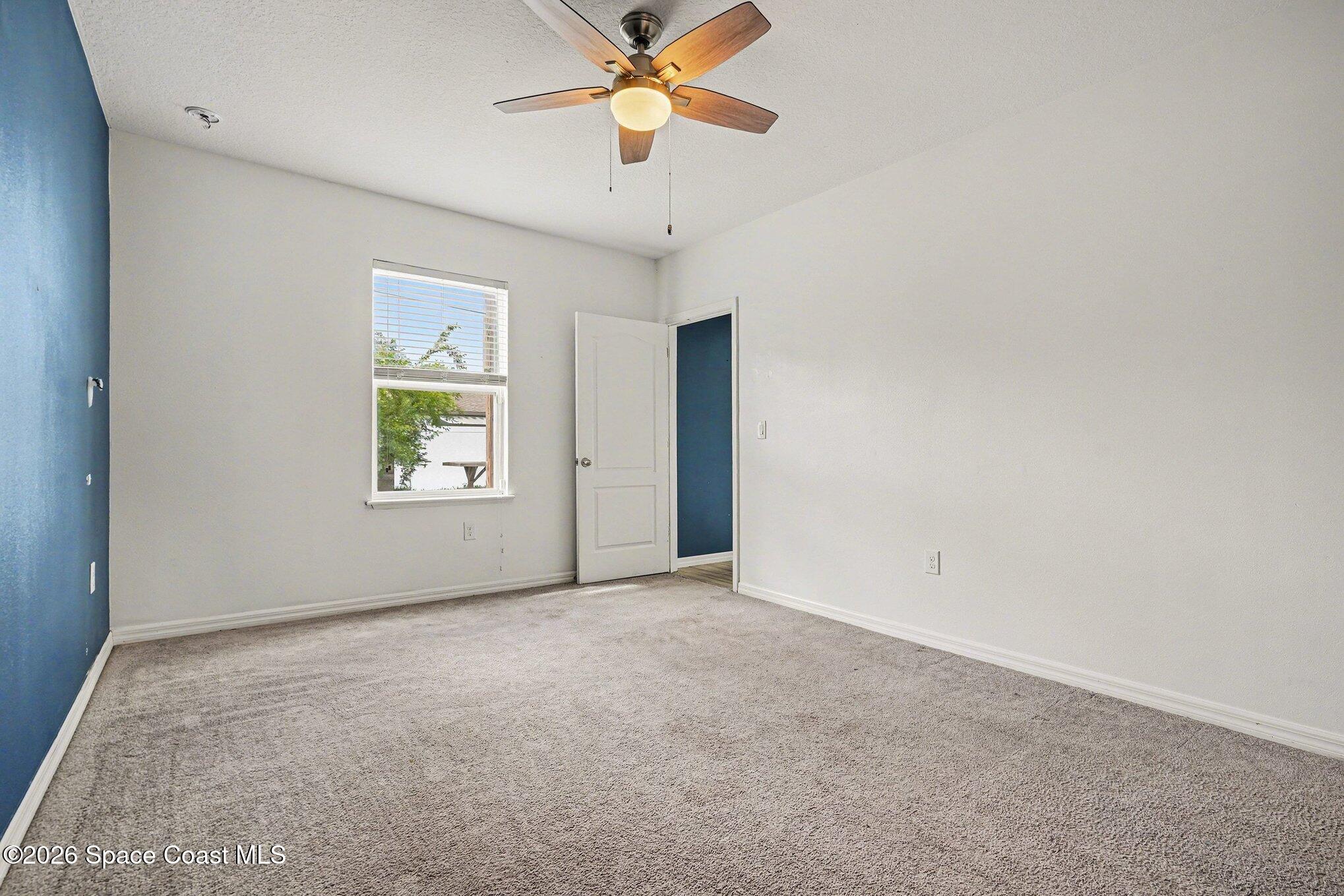 414 Hancock Street Palm Bay, FL 32908 - Photo 13 of 31 an empty room with a window and a fan