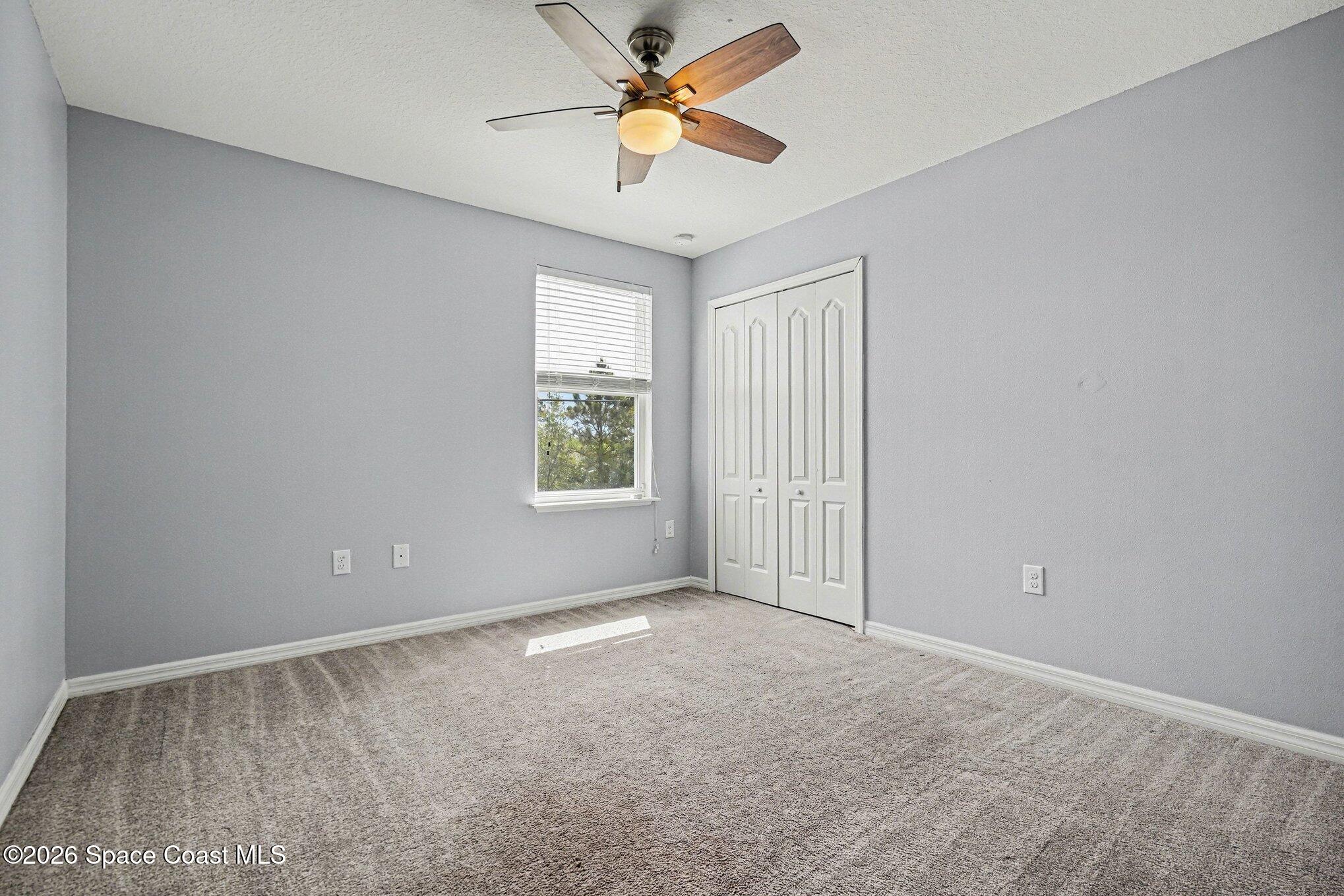 414 Hancock Street Palm Bay, FL 32908 - Photo 16 of 31 an empty room with windows and fan