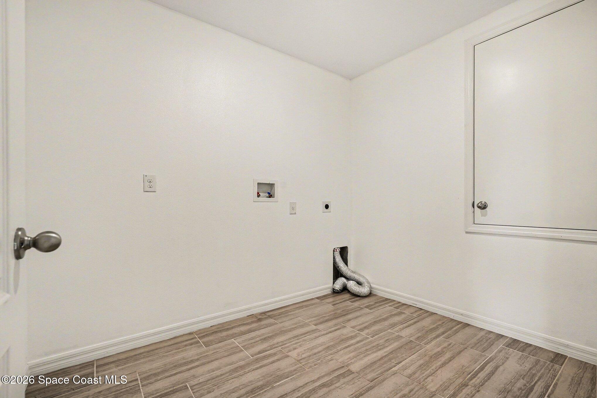 414 Hancock Street Palm Bay, FL 32908 - Photo 18 of 31 a view of empty room with wooden floor