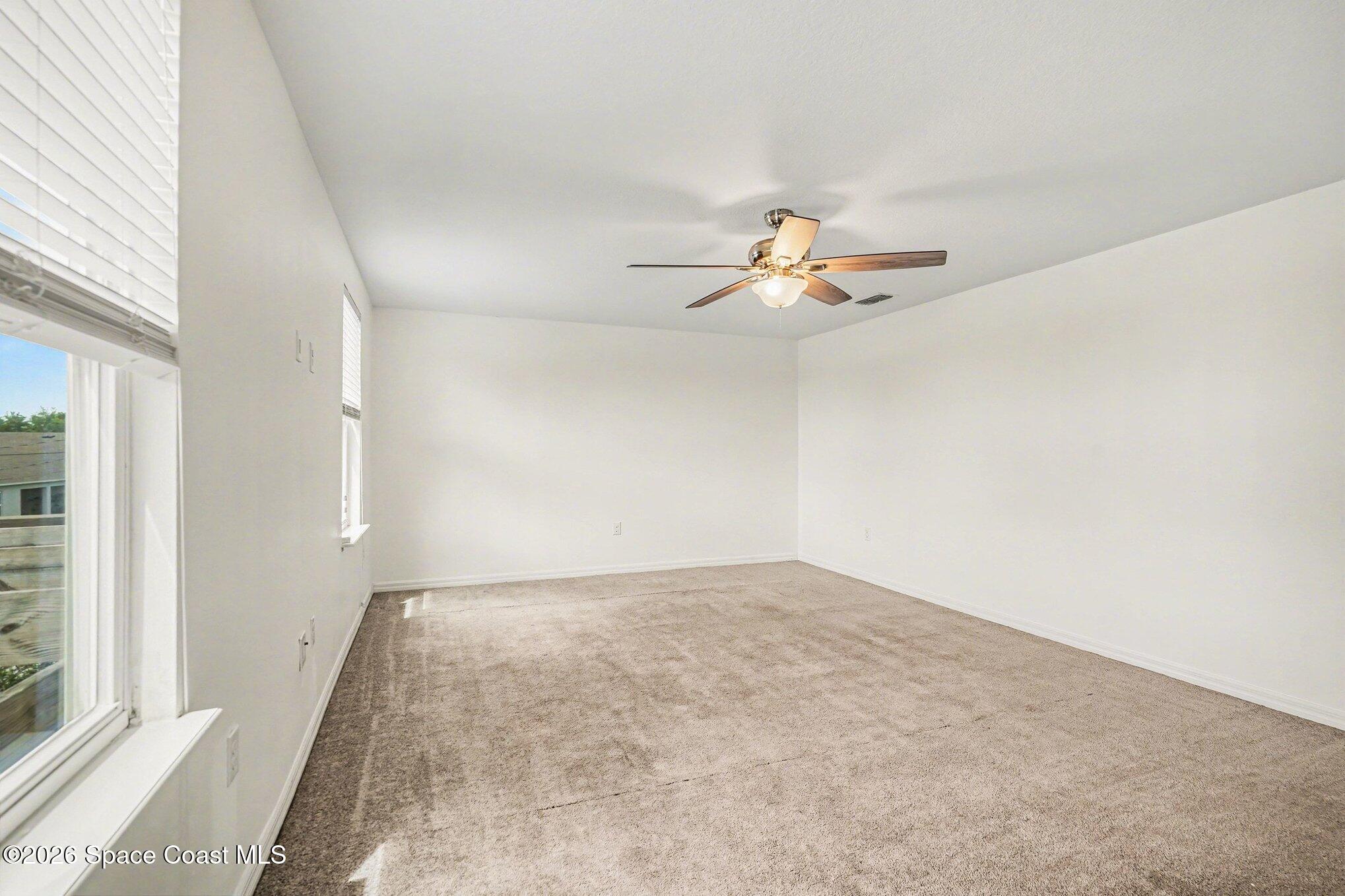 414 Hancock Street Palm Bay, FL 32908 - Photo 20 of 31 an empty room with fan and windows