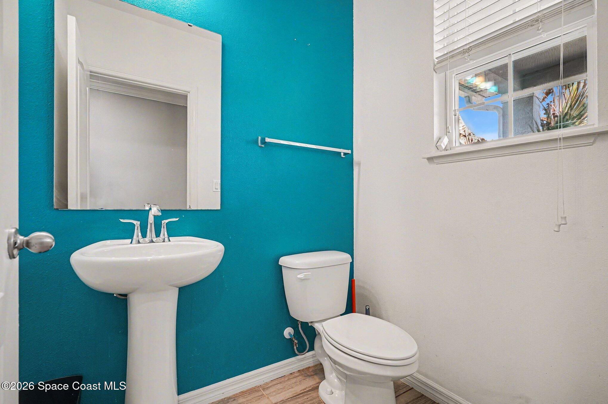 414 Hancock Street Palm Bay, FL 32908 - Photo 21 of 31 a bathroom with a sink toilet and a mirror