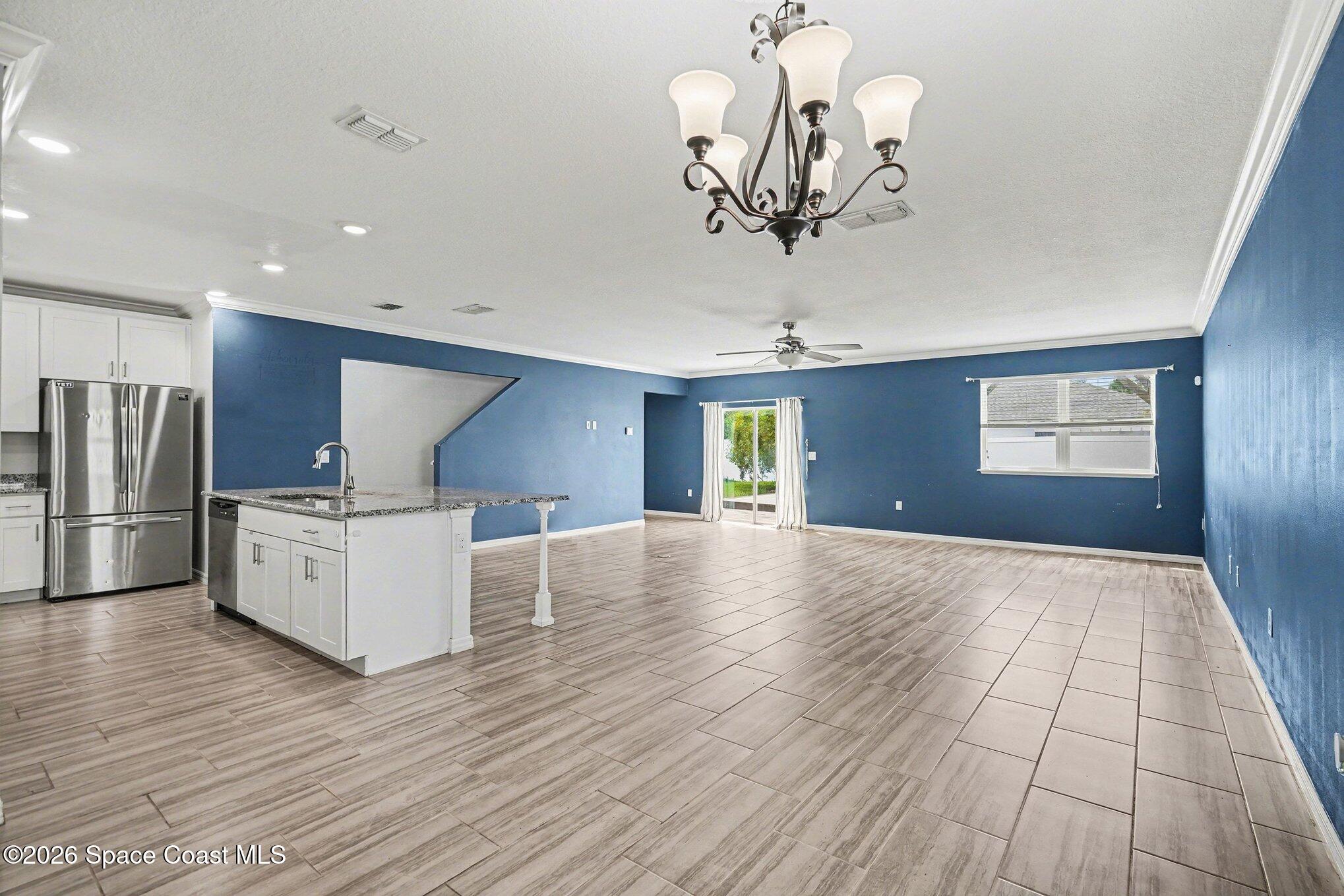 414 Hancock Street Palm Bay, FL 32908 - Photo 5 of 31 a view of a livingroom with an entryway and a ceiling fan