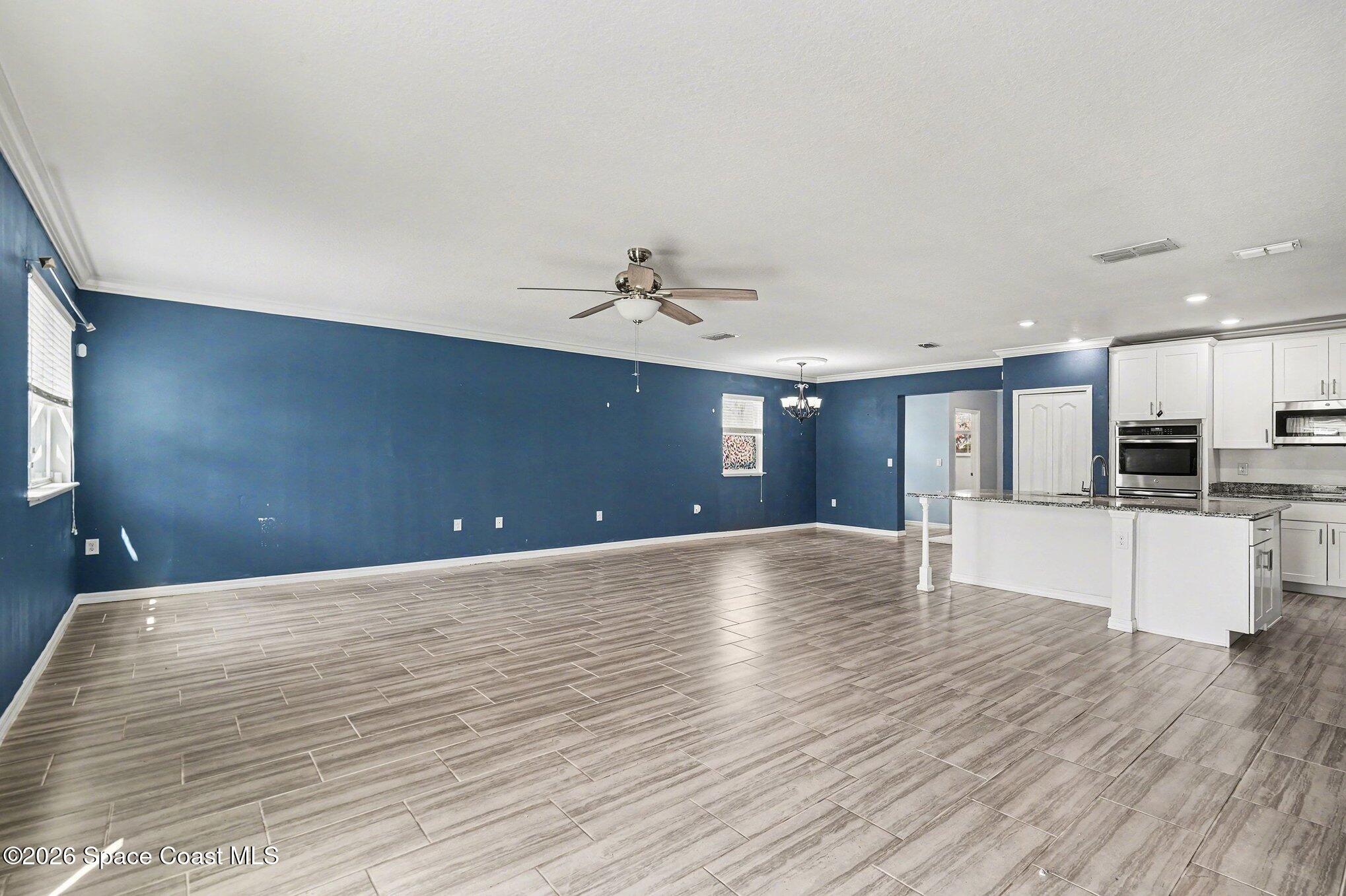 414 Hancock Street Palm Bay, FL 32908 - Photo 6 of 31 a view of a livingroom with a kitchen counter tops and wooden floor