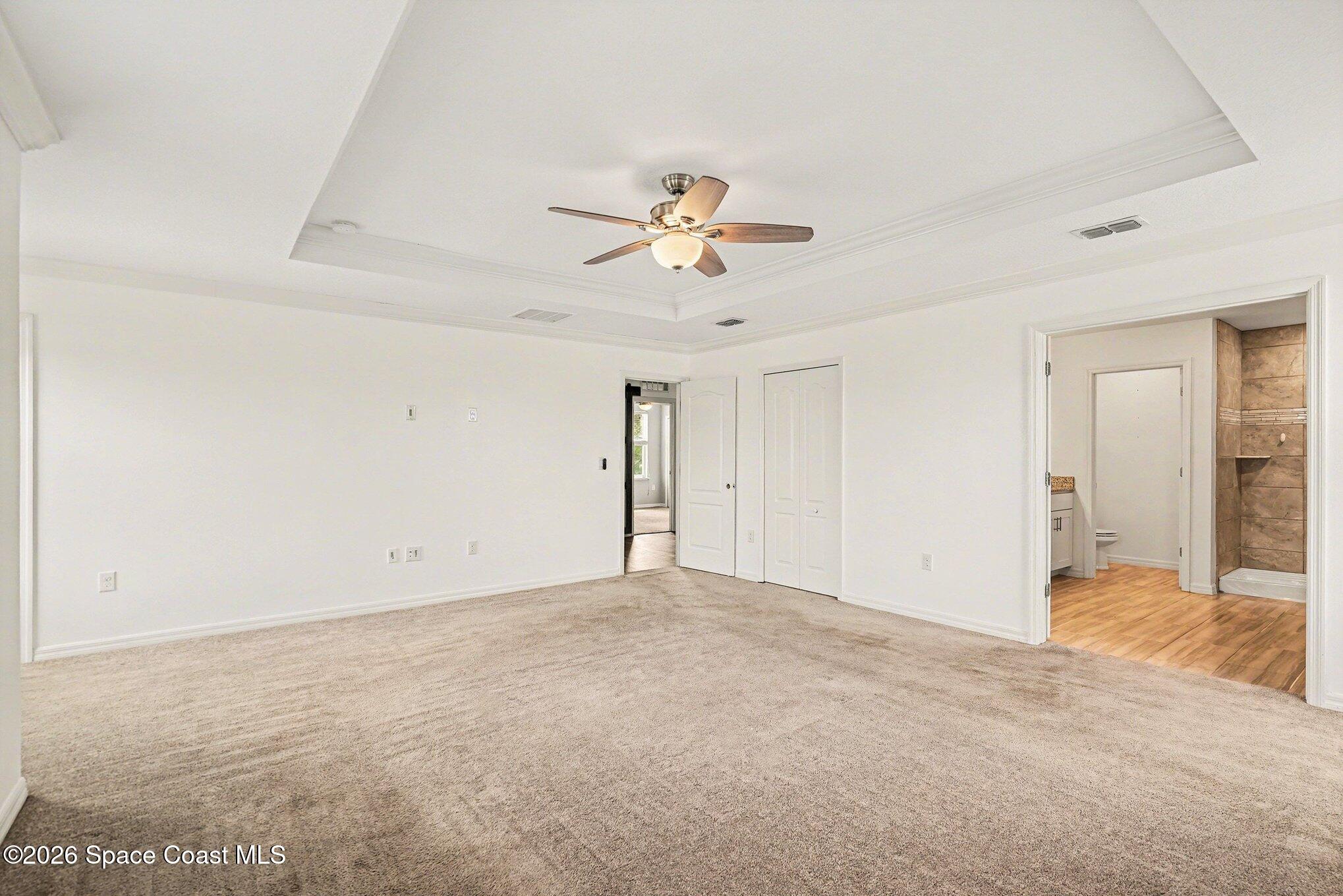 414 Hancock Street Palm Bay, FL 32908 - Photo 7 of 31 a view of a room with a ceiling fan and carpet