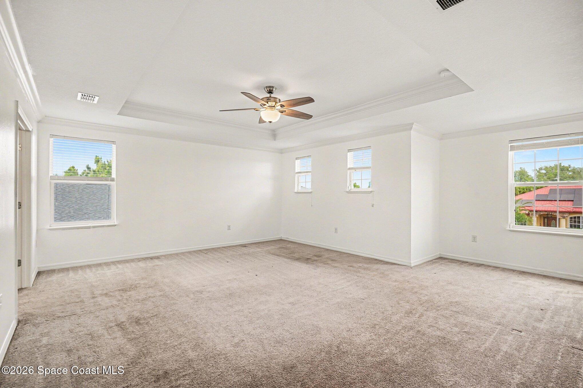 414 Hancock Street Palm Bay, FL 32908 - Photo 8 of 31 an empty room with windows and ceiling fan