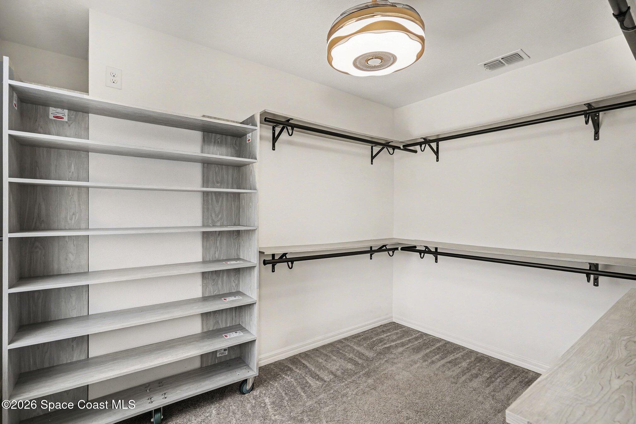 414 Hancock Street Palm Bay, FL 32908 - Photo 10 of 31 a view of walk in closet with empty racks