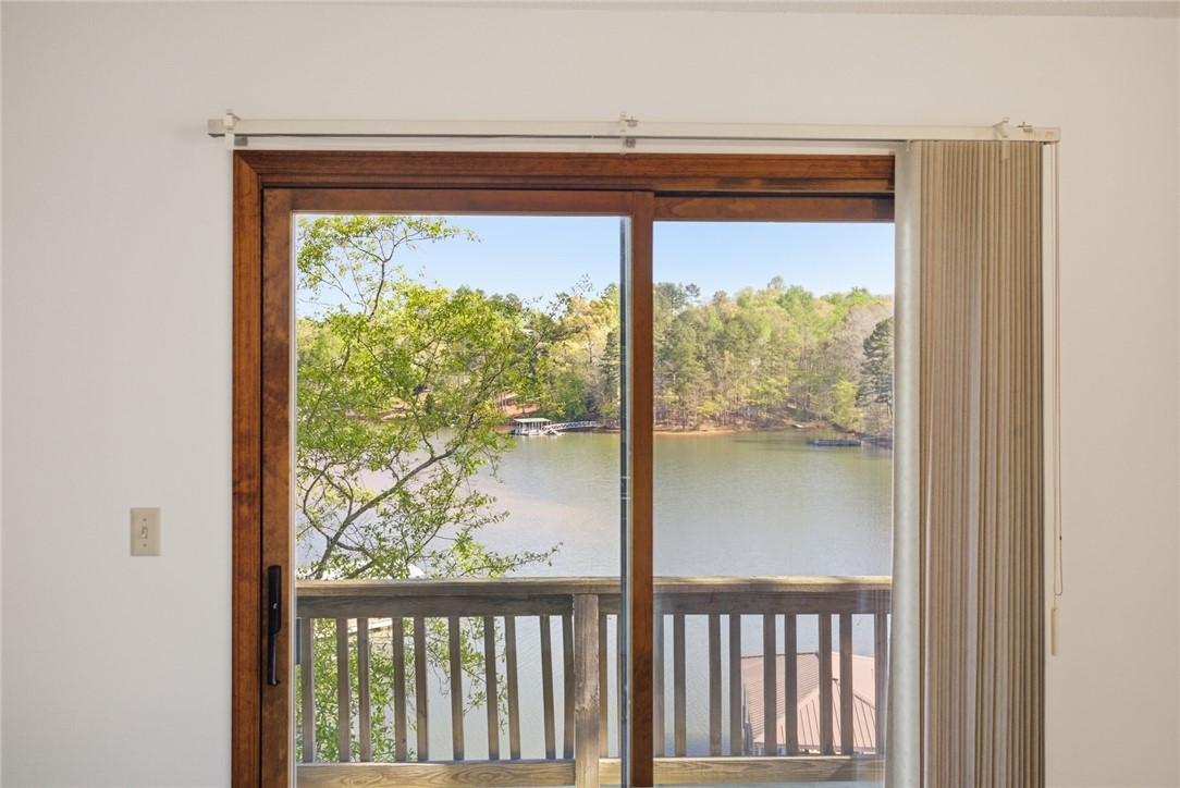 120 Farris Sandra Road West Union, SC 29696 - Photo 21 of 50 This interior view showcases beautiful lake views from a sliding glass door, offering serene natural surroundings.
