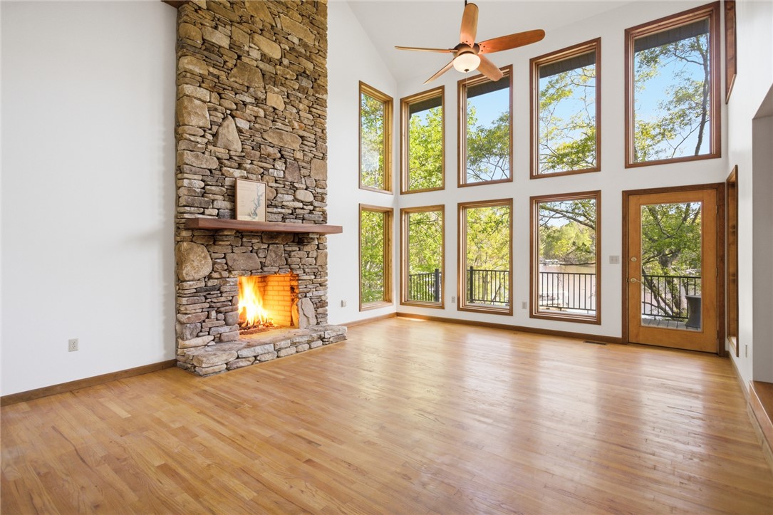 120 Farris Sandra Road West Union, SC 29696 - Photo 4 of 50 This airy living space features a captivating stone fireplace, warm wood floors, and expansive windows.