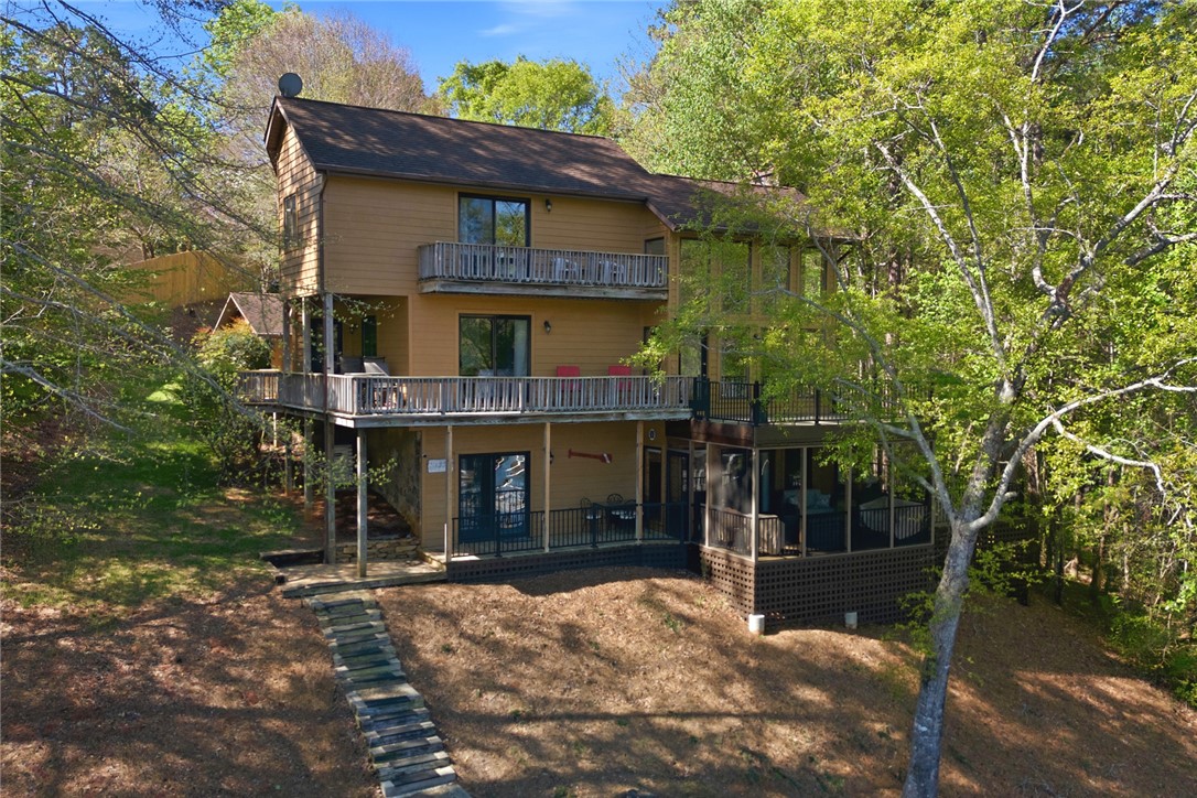 120 Farris Sandra Road West Union, SC 29696 - Photo 46 of 50 This elevated residence boasts multiple balconies and a screened porch, surrounded by lush trees.
