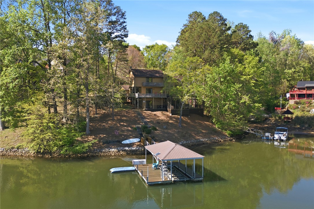 120 Farris Sandra Road West Union, SC 29696 - Photo 47 of 50 This lakeside home offers expansive outdoor living and direct water access, nestled amongst lush greenery.