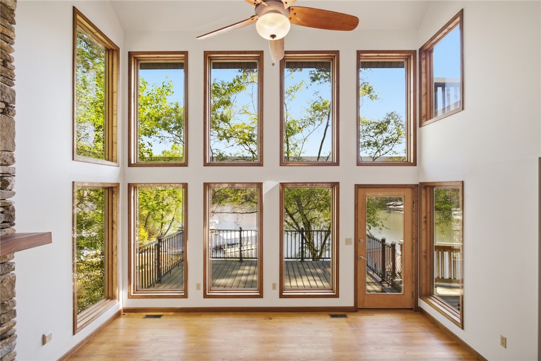 120 Farris Sandra Road West Union, SC 29696 - Photo 5 of 50 Floor-to-ceiling windows flood this airy living space with natural light and lake views.