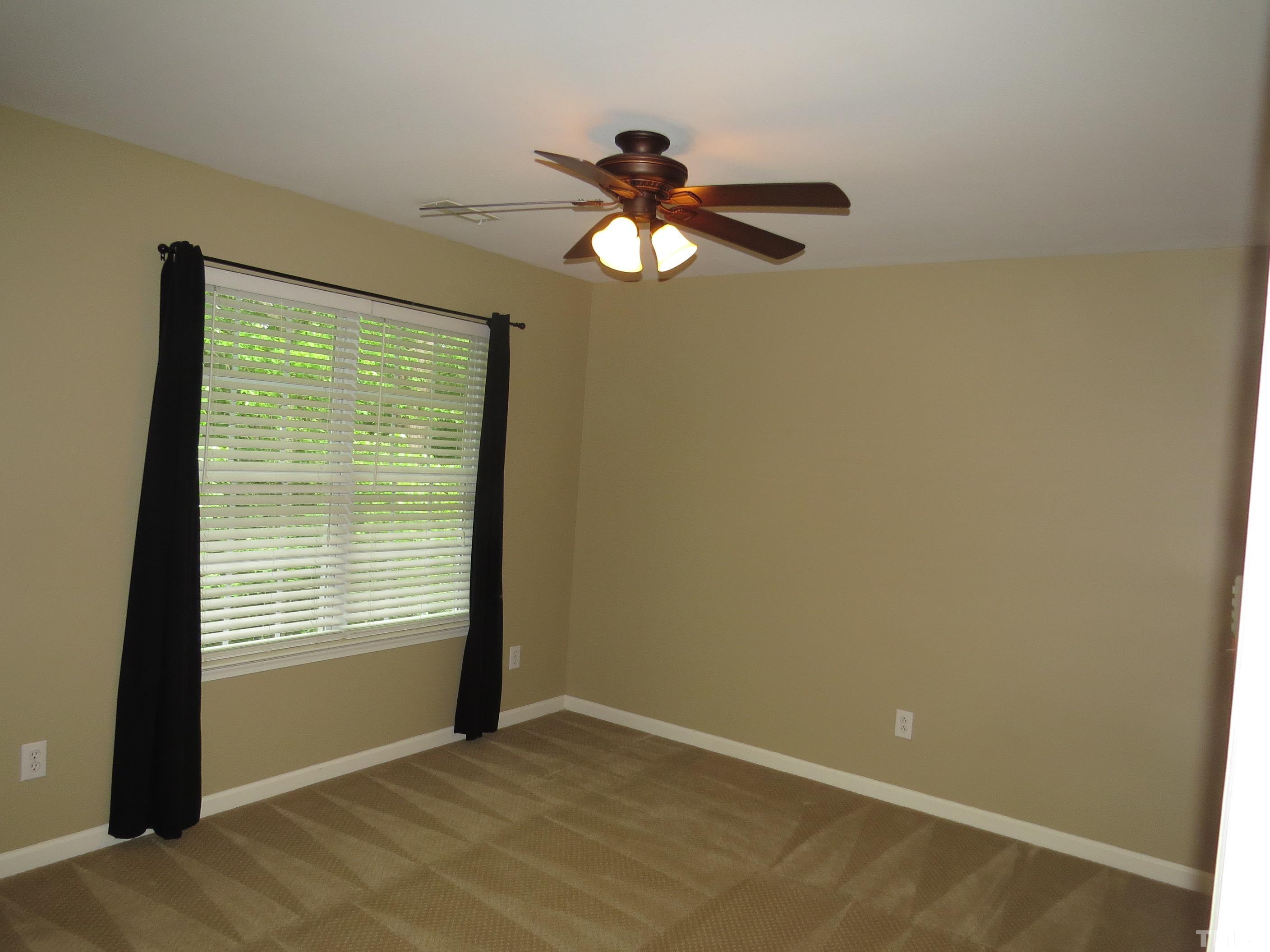 12202 Fox Valley Street Raleigh, NC 27614 - Photo 14 of 24 a view of an empty room with a window