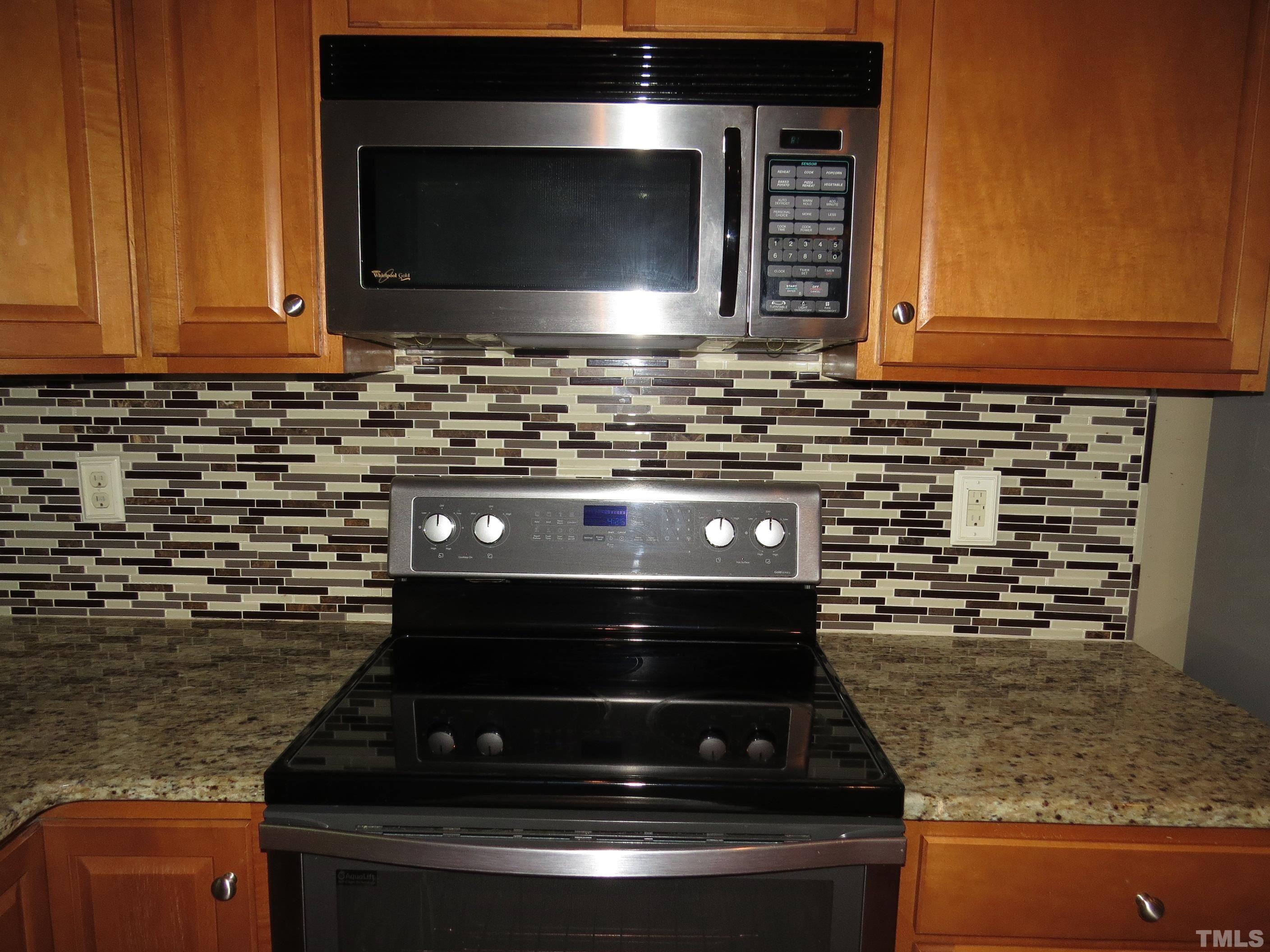12202 Fox Valley Street Raleigh, NC 27614 - Photo 4 of 24 a stove top oven sitting inside of a kitchen