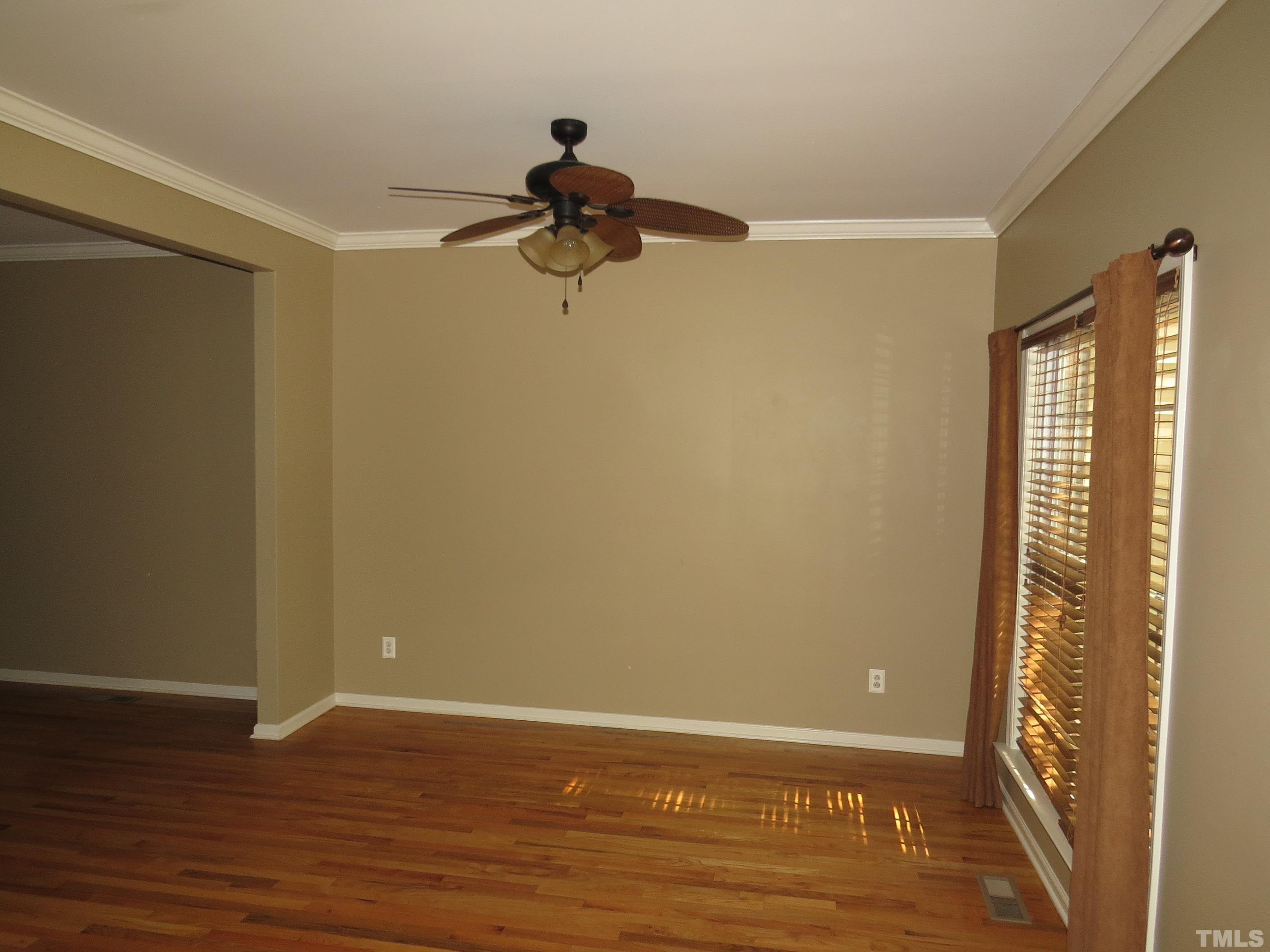 12202 Fox Valley Street Raleigh, NC 27614 - Photo 6 of 24 a view of a room with wooden floor and brick walls