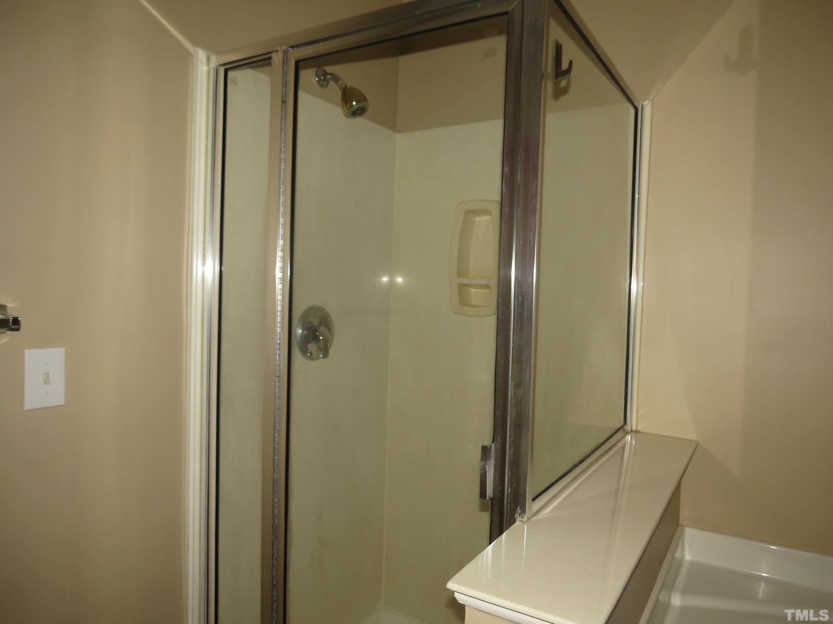 12202 Fox Valley Street Raleigh, NC 27614 - Photo 9 of 24 a bathroom with a tub and shower
