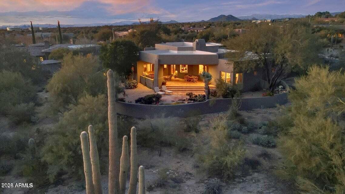 10040 East Happy Valley Road, Unit 404 Scottsdale, AZ 85255 - Photo 1 of 4 an aerial view of residential houses with outdoor space and trees