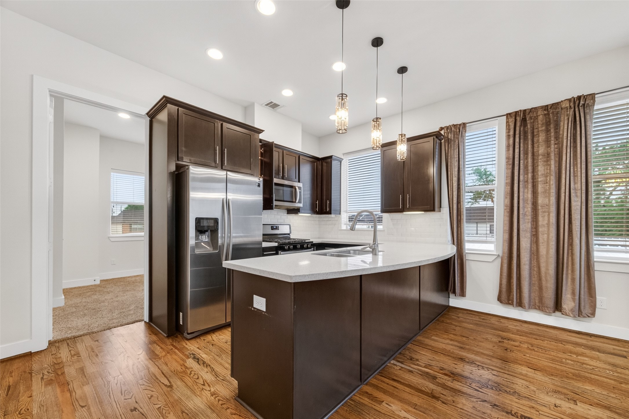 1202 Cedarpost Tree Springs Place Houston, TX 77055 - Photo 11 of 45 a kitchen with stainless steel appliances a sink stove and refrigerator