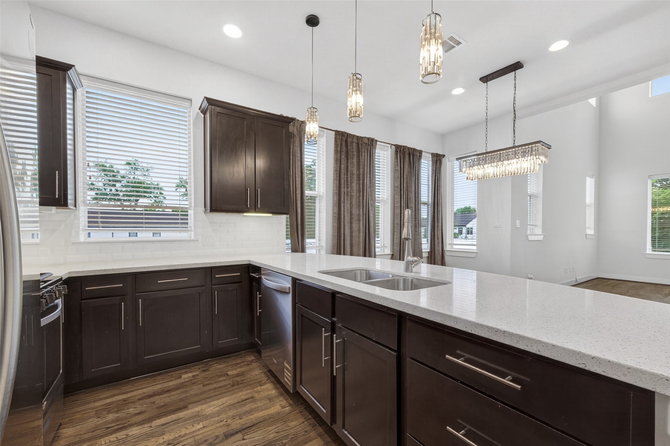 1202 Cedarpost Tree Springs Place Houston, TX 77055 - Photo 13 of 45 a large kitchen with a center island wooden cabinets and stainless steel appliances