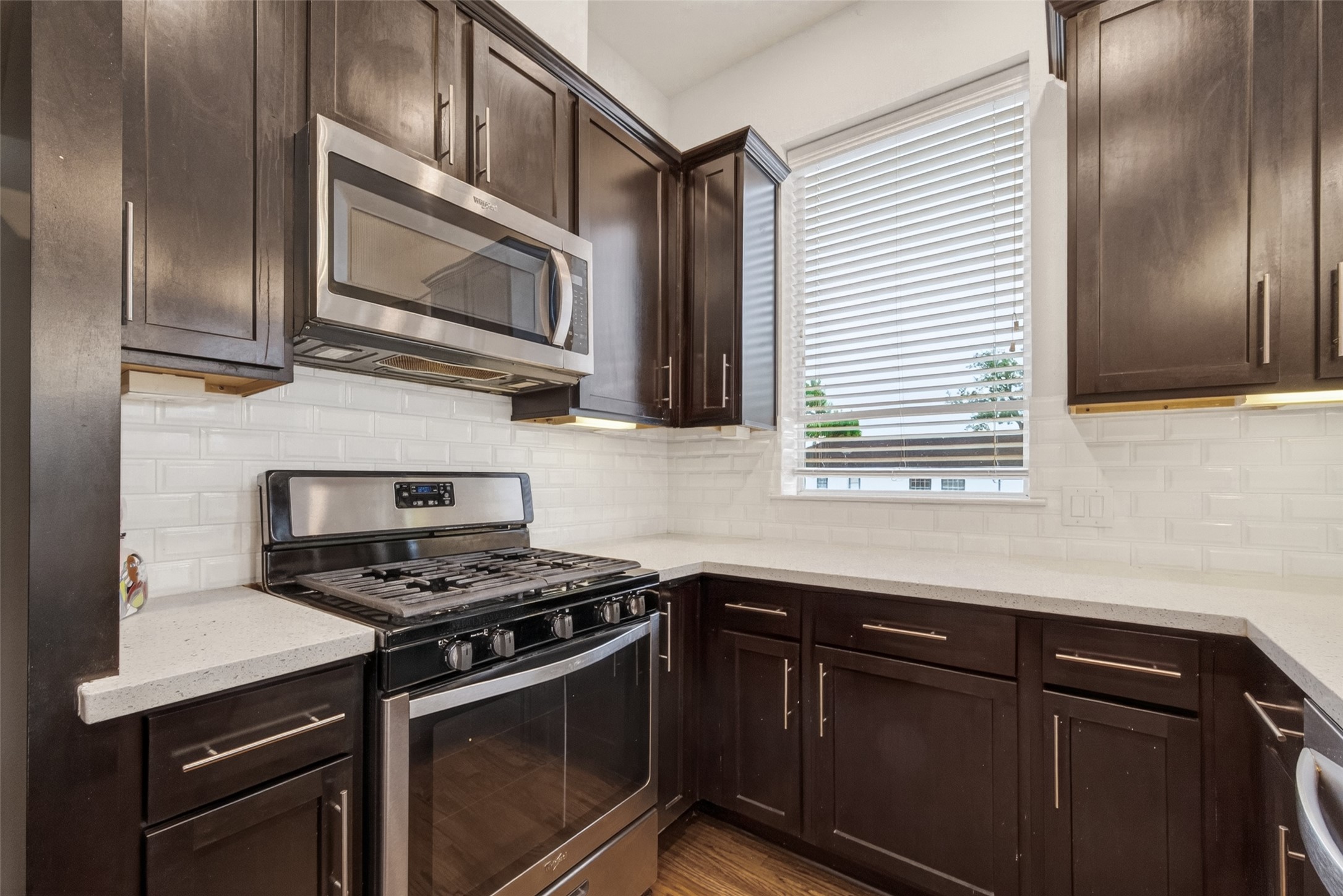 1202 Cedarpost Tree Springs Place Houston, TX 77055 - Photo 15 of 45 a kitchen with stainless steel appliances granite countertop a sink stove and microwave