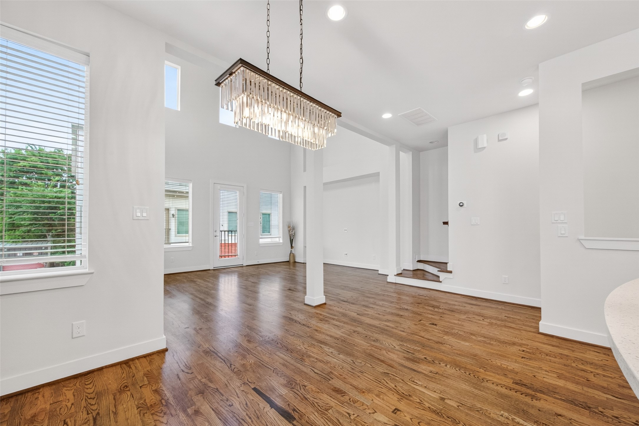 1202 Cedarpost Tree Springs Place Houston, TX 77055 - Photo 19 of 45 a view of an empty room with wooden floor and a window
