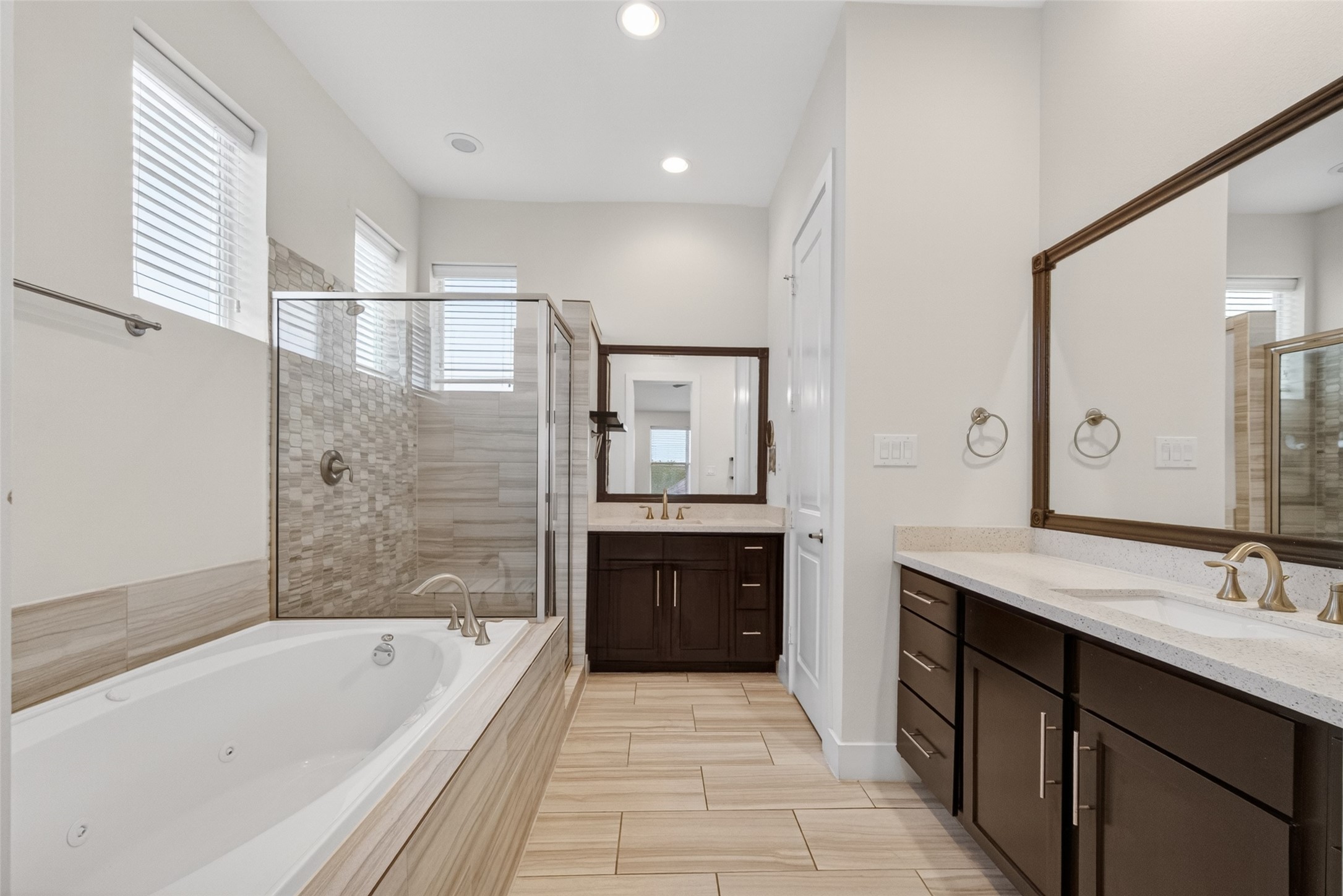 1202 Cedarpost Tree Springs Place Houston, TX 77055 - Photo 25 of 45 a bathroom with a tub a sink a mirror and a shower