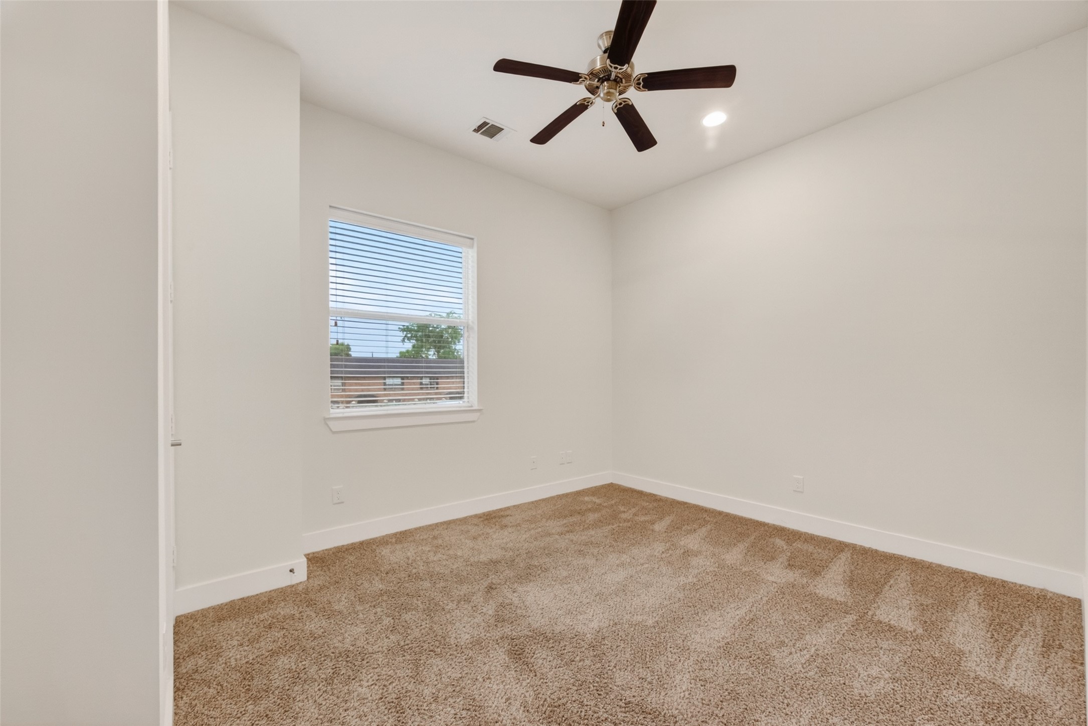 1202 Cedarpost Tree Springs Place Houston, TX 77055 - Photo 31 of 45 an empty room with a window and a fan