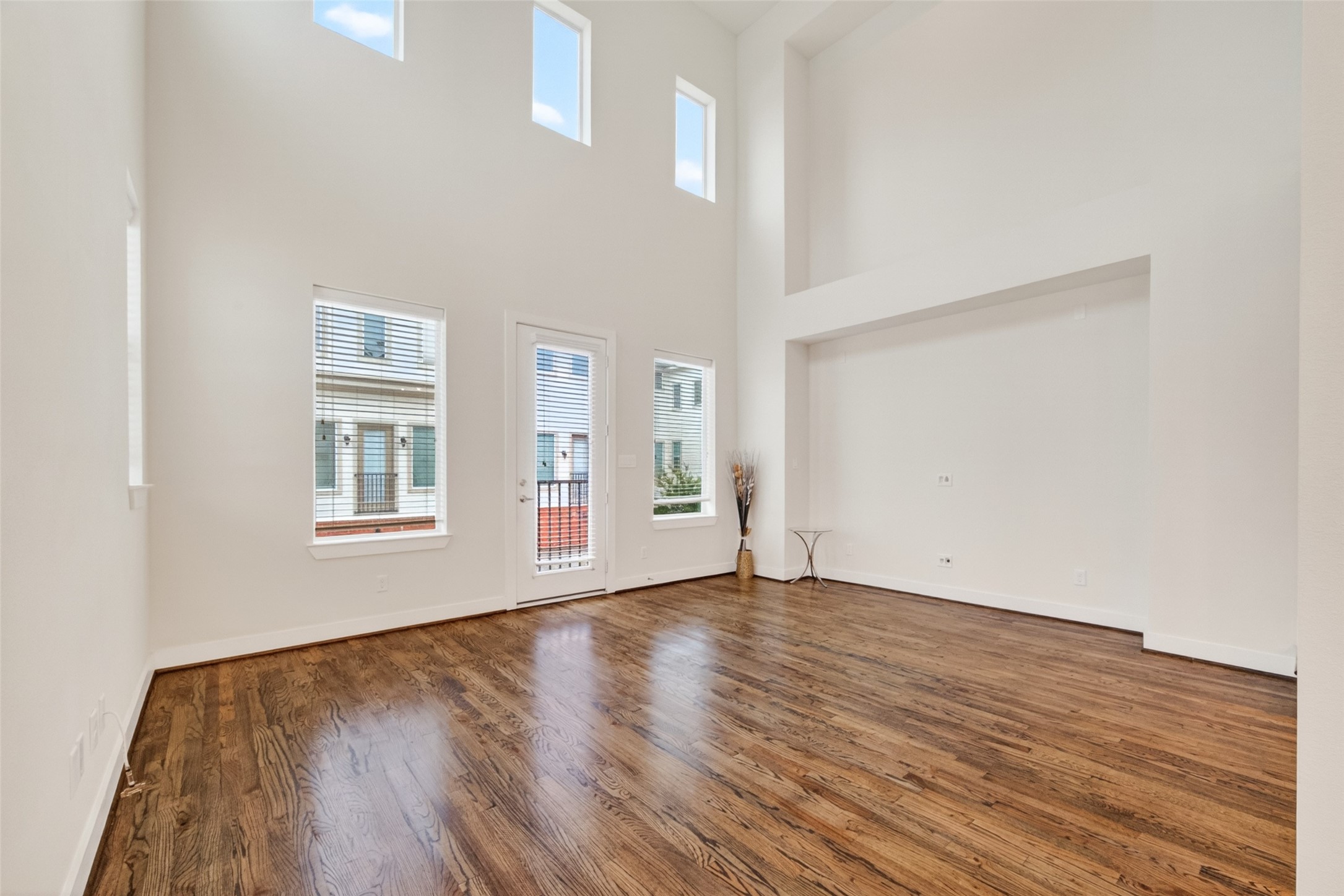 1202 Cedarpost Tree Springs Place Houston, TX 77055 - Photo 6 of 45 a view of an empty room with wooden floor and a window