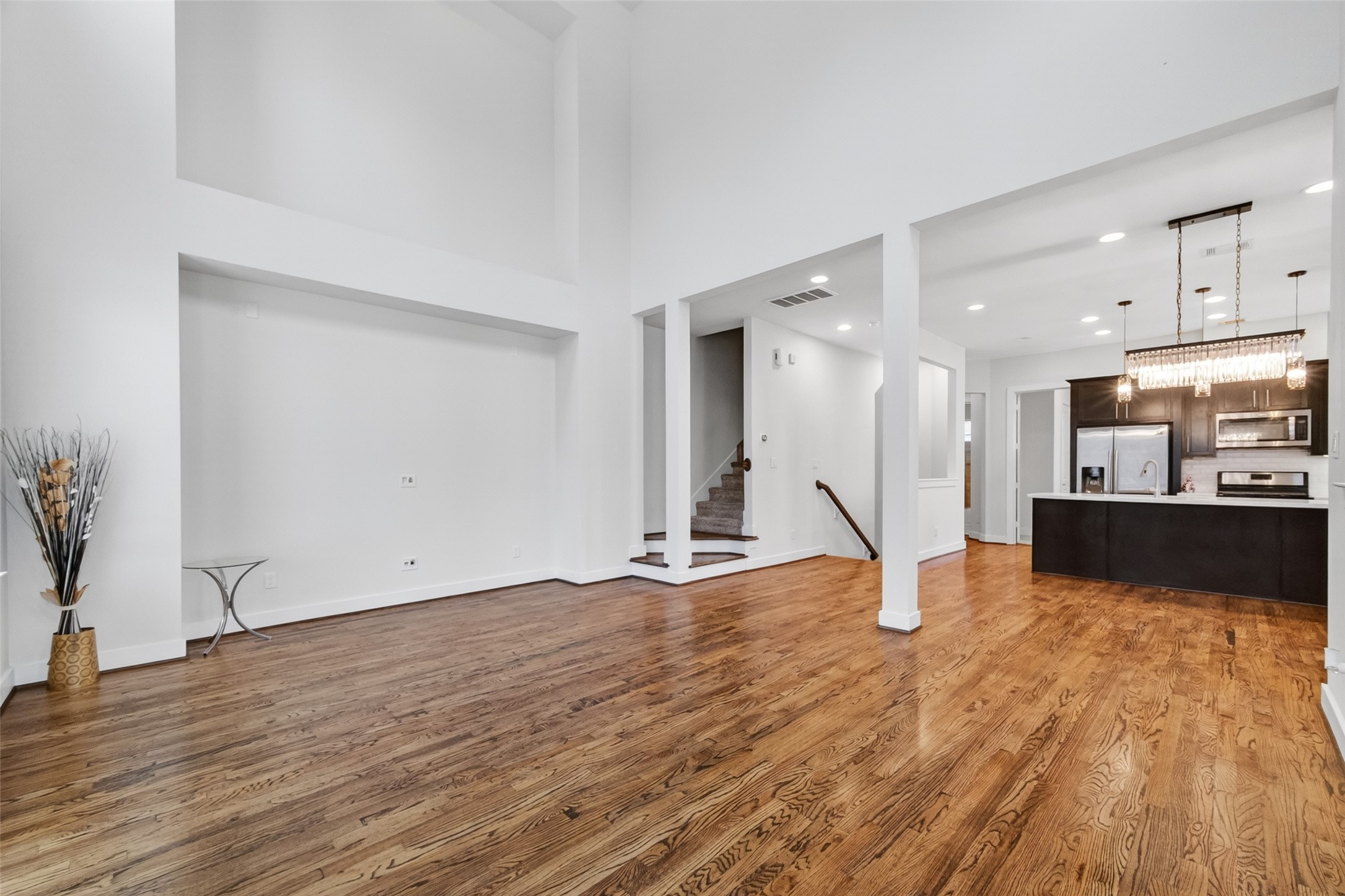 1202 Cedarpost Tree Springs Place Houston, TX 77055 - Photo 7 of 45 a view of a kitchen with a sink and a wooden floor
